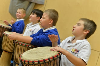 Four boys playing drums