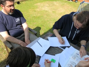 Silver drawing workshops taking place at home with family members