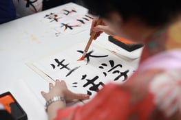 Someone writing Japanese caligraphy