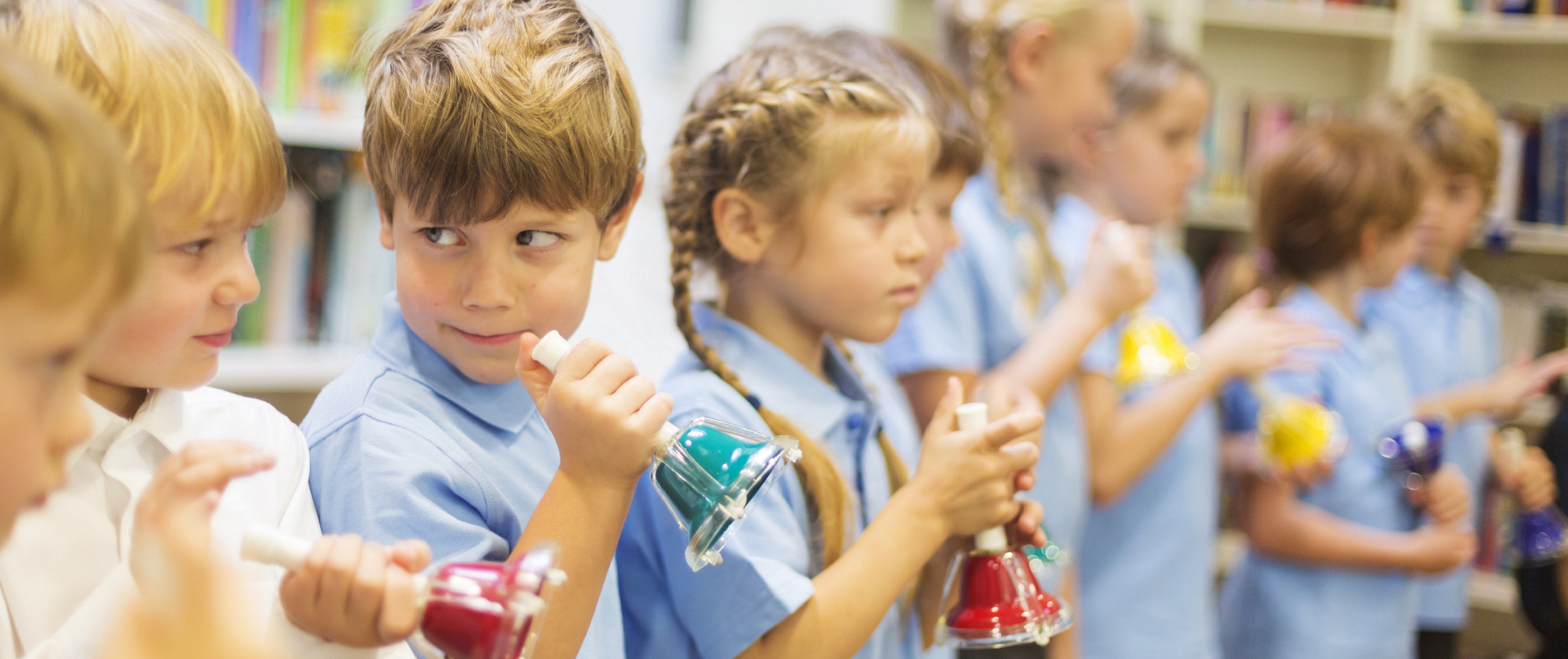 School children are lined up ready to play hand bells